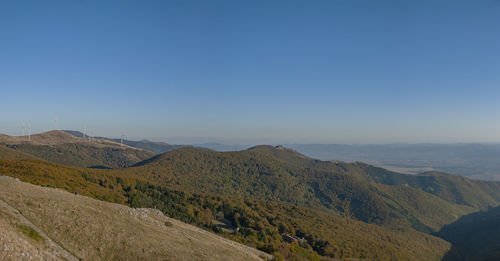 Scenic view of mountains against clear blue sky