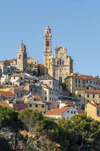 View of buildings in city against clear sky