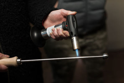 Close-up of man working on metal