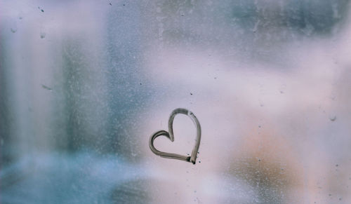 Close-up of heart shape on glass