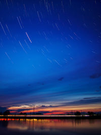 Scenic view of lake against star trails