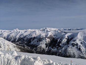 Scenic view of snowcapped mountains against sky