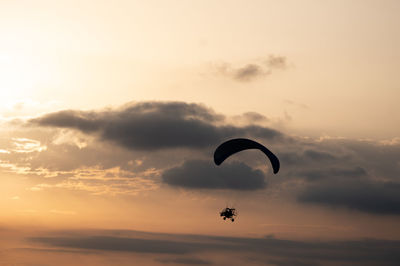 Paramotor silhouette with dramatic background skies