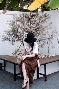 Portrait of young woman sitting on chair