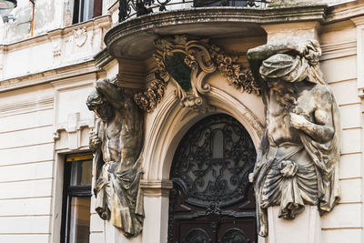 Low angle view of statue against historic building