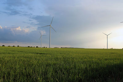 Windmill on field against sky