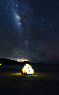 Scenic view of illuminated tent against sky at night