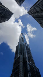 Low angle view of buildings against cloudy sky