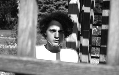 Portrait of tensed man seen through fence