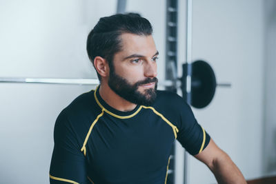 Portrait of beautiful sweaty man after a training gym session sporty boy at the end of the work out