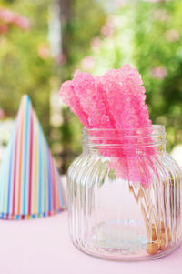 Close-up of pink dessert in glass jar on table