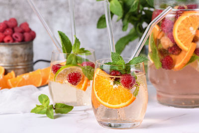 Summer sangria cocktail or lemonade with raspberry, orange and mint. organic detox healthy drink 