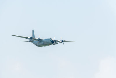 Low angle view of airplane flying against clear sky