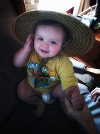 Portrait of cute baby girl sitting at home