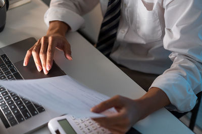 Midsection of business people working at office