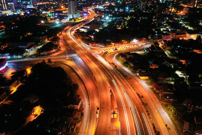 High angle view of light trails on road at night