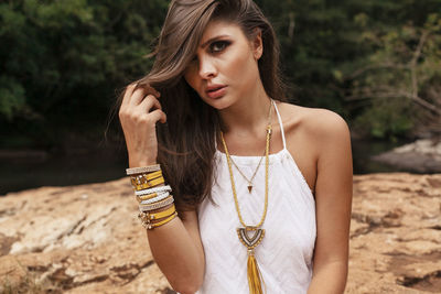 Portrait of beautiful young woman sitting outdoors