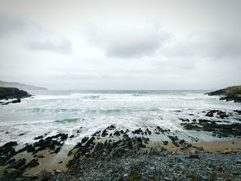 Scenic view of sea against cloudy sky