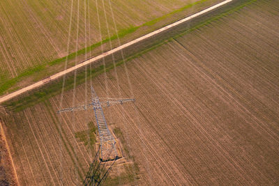 Aerial view of power lines and pylons necessary for the german energiewende on a agricultural field