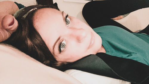 Portrait of woman lying on bed
