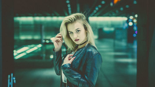 Portrait of young woman at railroad station