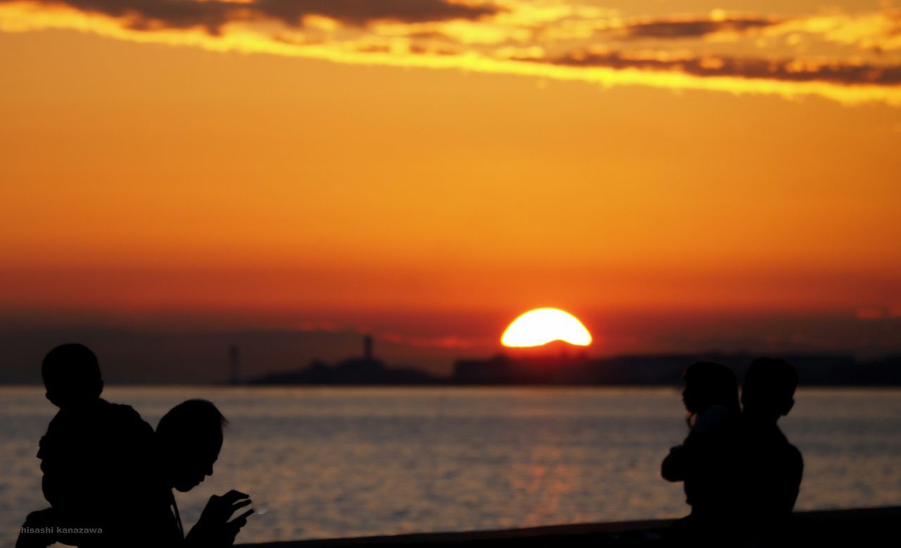 SILHOUETTE PEOPLE ON SEA AGAINST ORANGE SKY