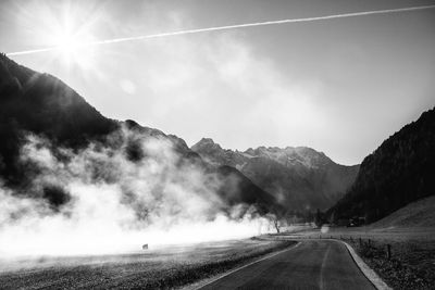 Road amidst mountains against sky