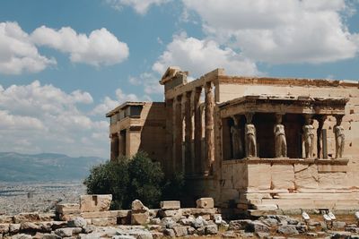 Greek temple against cloudy sky