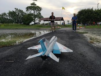 People standing by road against sky