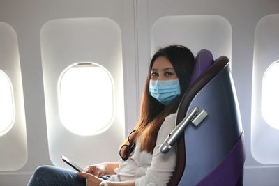 Portrait of woman sitting in airplane