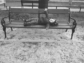 Boy sitting on playground at park