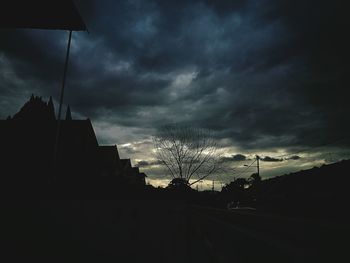 Low angle view of silhouette trees against sky