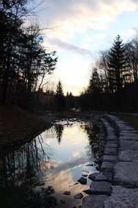 Scenic view of lake against sky at sunset