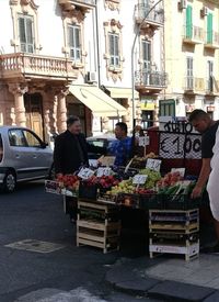 People at market stall in city