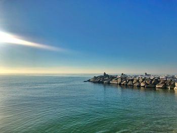 Scenic view of sea against blue sky