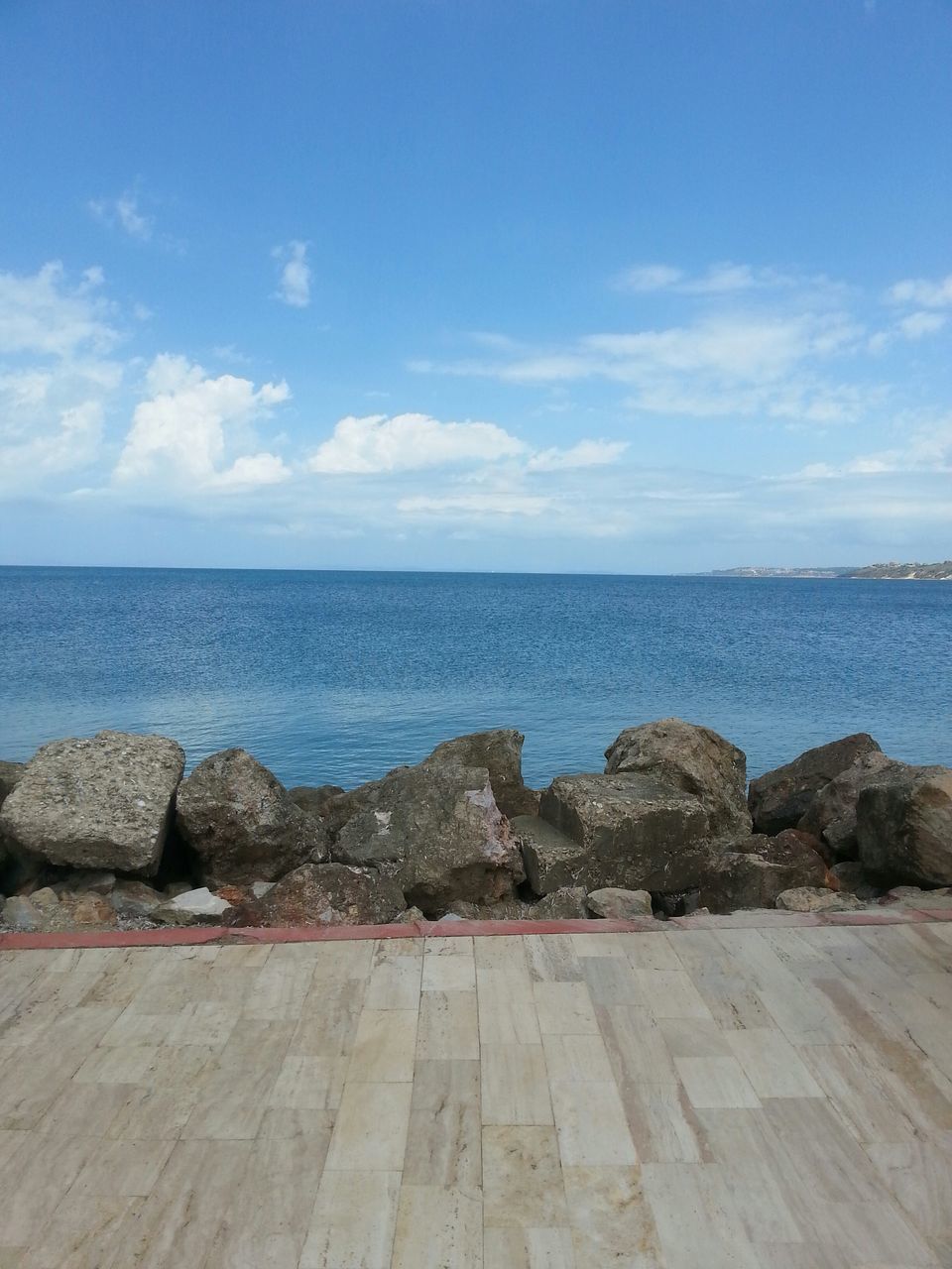 sea, horizon over water, sky, water, scenics, tranquil scene, blue, tranquility, beach, beauty in nature, rock - object, nature, cloud - sky, shore, cloud, day, idyllic, outdoors, rock formation, remote