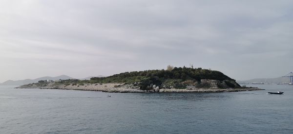 Scenic view of sea and mountains against sky