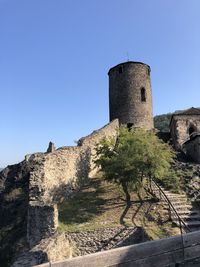 Low angle view of castle against clear blue sky