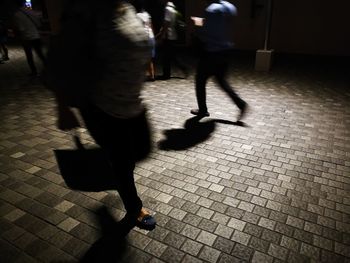 Low section of man walking on sidewalk