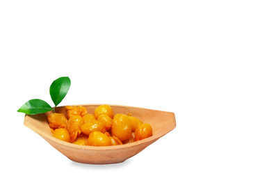 Close-up of fruits in bowl against white background