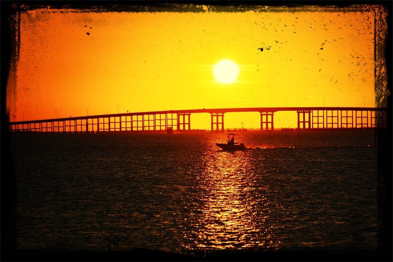 sunset, water, sun, transfer print, sea, waterfront, connection, orange color, tranquil scene, scenics, built structure, auto post production filter, sky, tranquility, beauty in nature, rippled, bridge - man made structure, nature, river, architecture