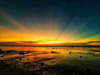 Scenic view of beach against sky during sunset