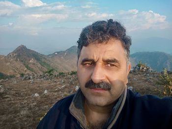 Portrait of man in mountains against sky