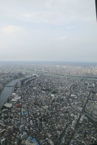 High angle view of cityscape by sea against sky