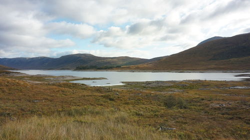 Scenic view of lake and mountains against sky