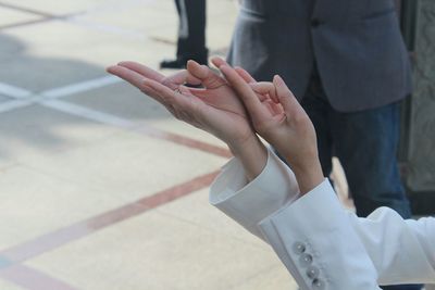 Low section of woman standing on tiled floor