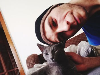 Portrait of woman with cat at home
