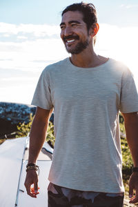 Smily man lit by the sun in a camp site