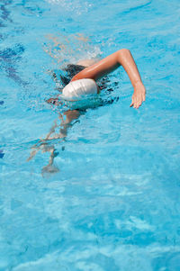 High angle view of woman swimming in pool