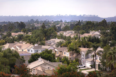 High angle view of houses and trees against clear sky